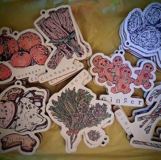 Handprinted BeeBirds wooden Christmas decorations inspired by festive scents including cinnamon, pine and oranges, handcrafted designs.