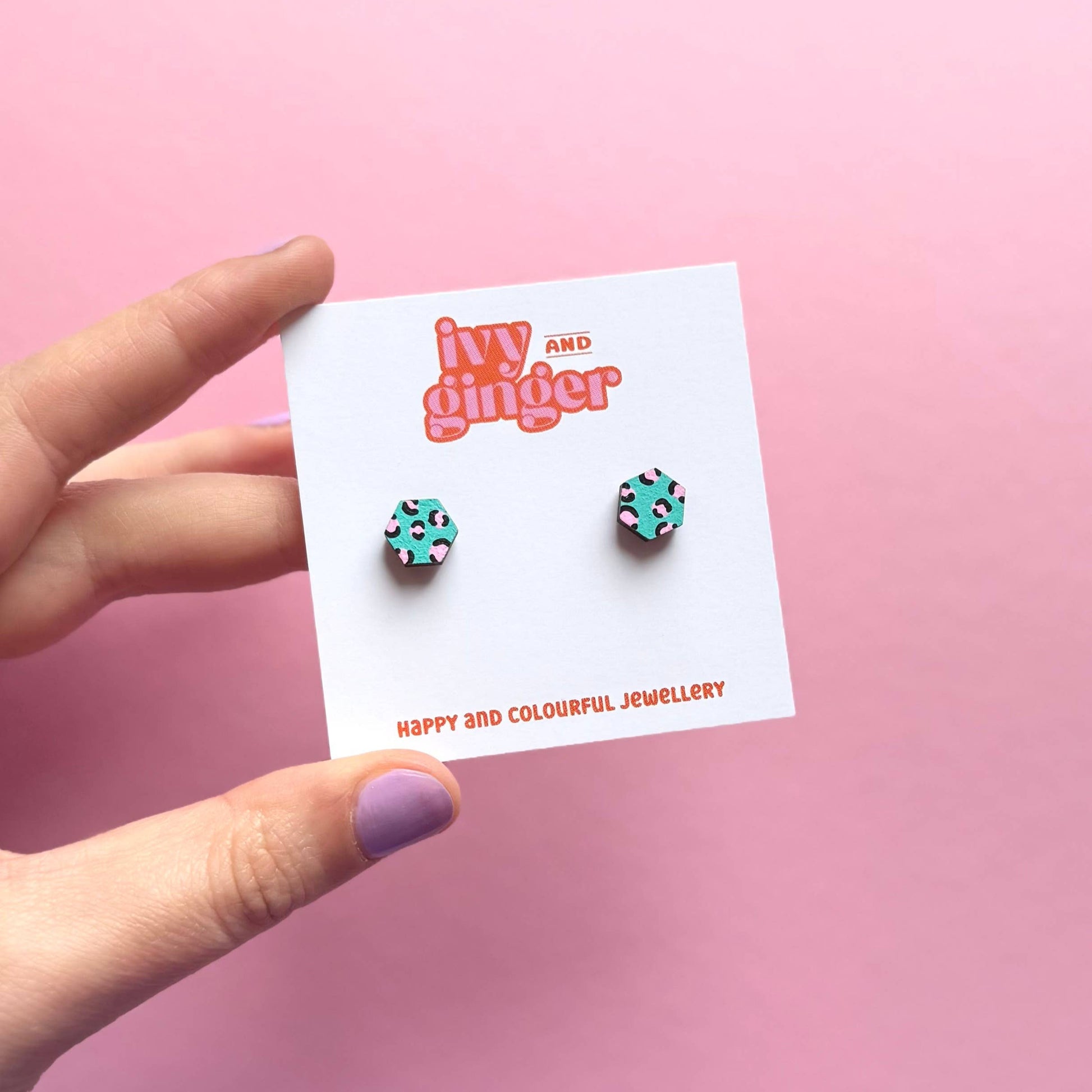 Hand painted green and pink hexagon stud earrings made from FSC wood with surgical steel posts, 10mm in size, lightweight and gift-ready.