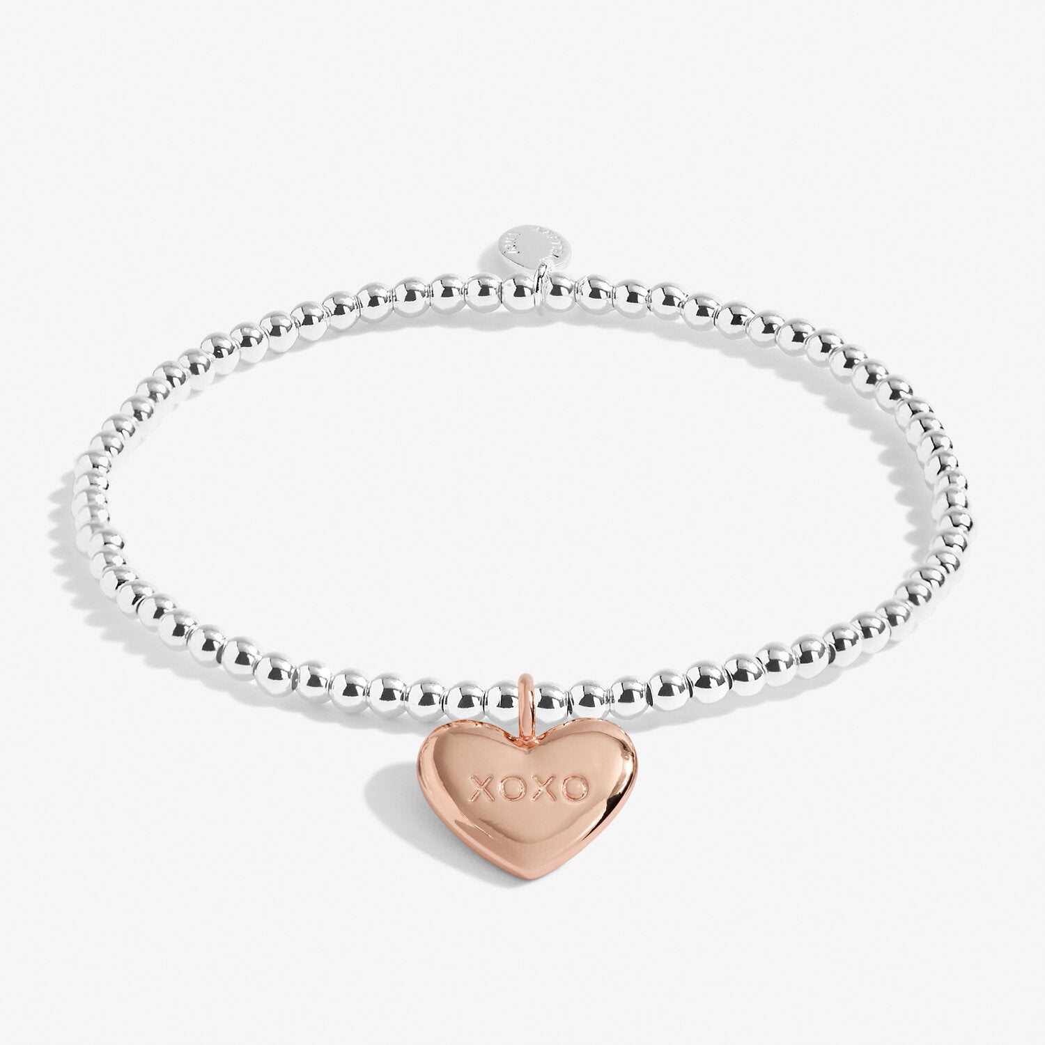 Silver plated stretch beaded bracelet with a rose gold plated heart charm, stamped 'XOXO' by Joma Jewellery