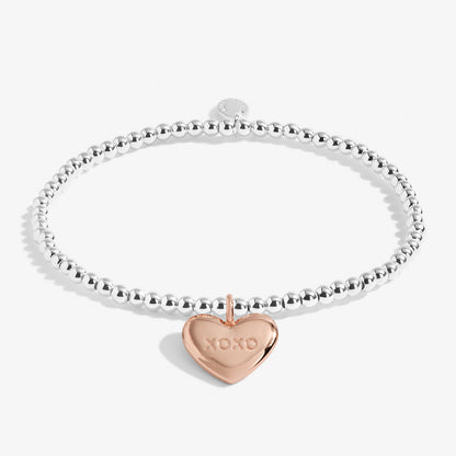 Silver plated stretch beaded bracelet with a rose gold plated heart charm, stamped 'XOXO' by Joma Jewellery