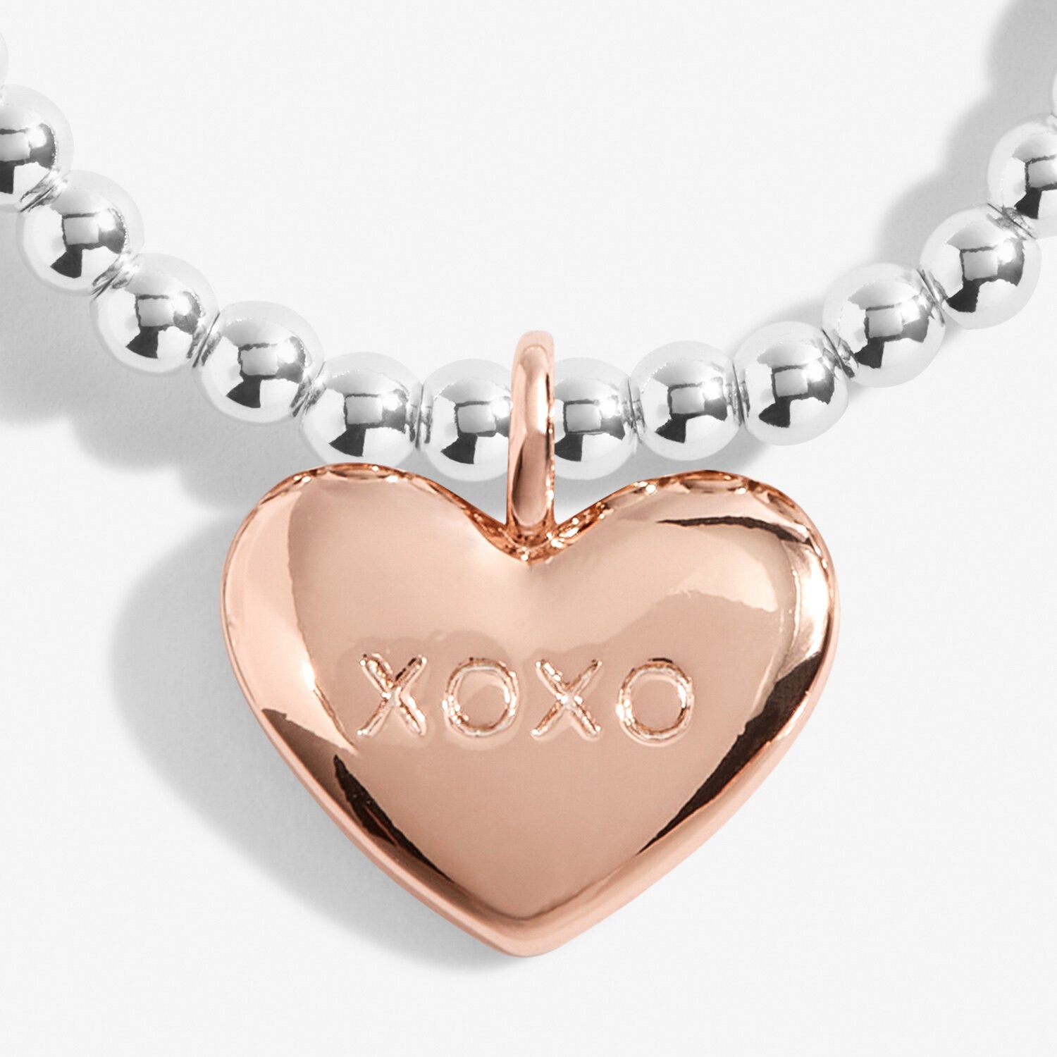 Silver plated stretch beaded bracelet with a rose gold plated heart charm, stamped 'XOXO' by Joma Jewellery