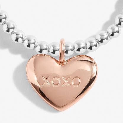 Silver plated stretch beaded bracelet with a rose gold plated heart charm, stamped 'XOXO' by Joma Jewellery