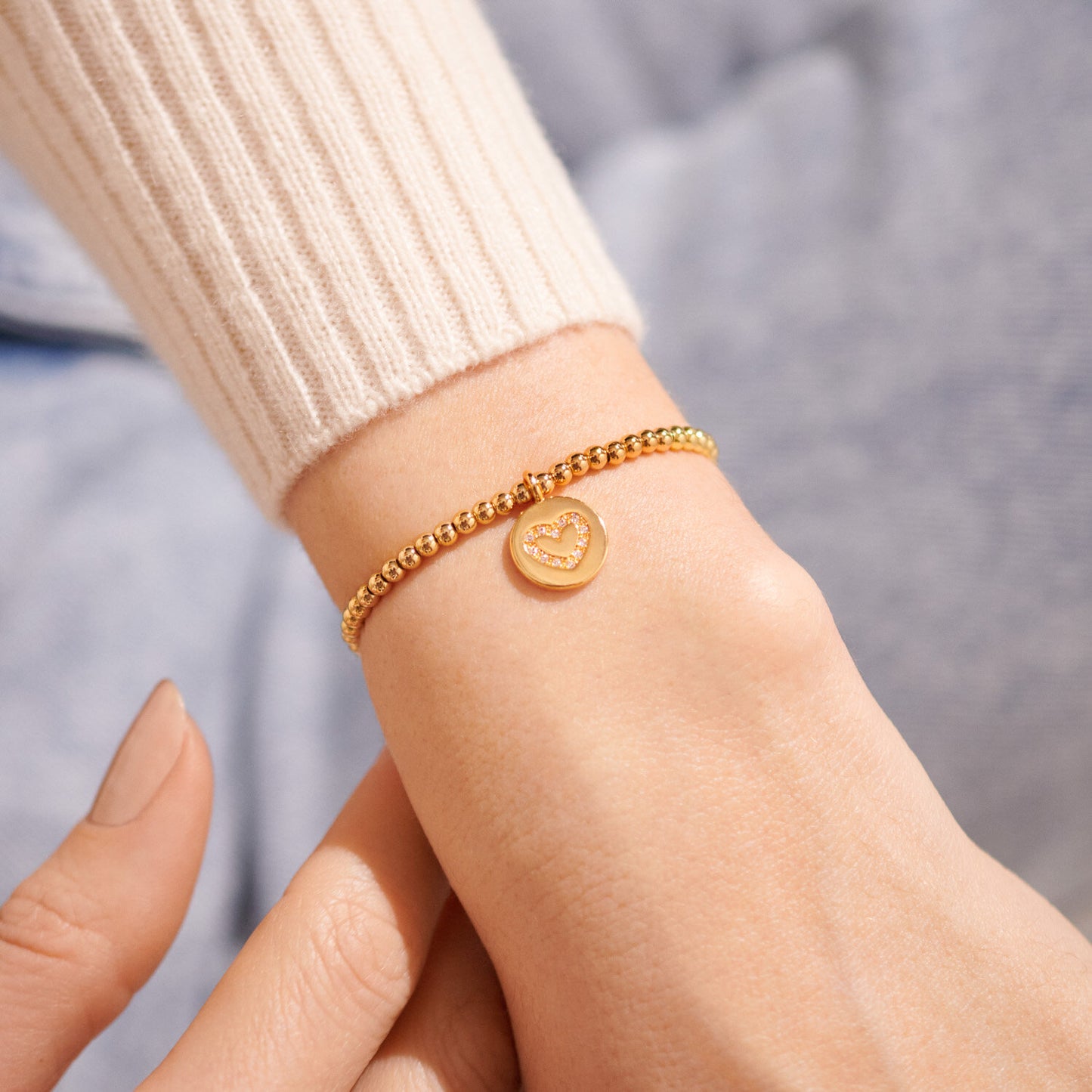 A LITTLE 'FAMILY' GOLD BRACELET