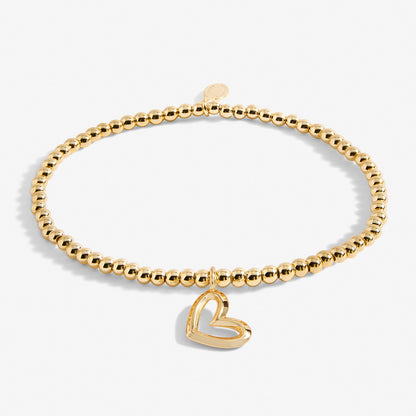 A gold plated stretch beaded bracelet with heart charm 
