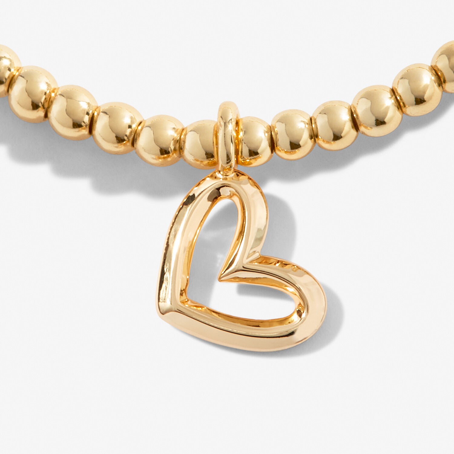 A gold plated stretch beaded bracelet with heart charm 