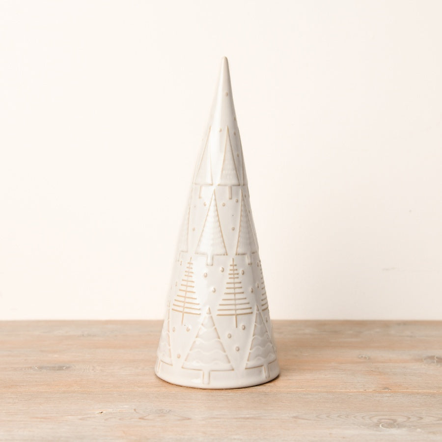 A decorative ceramic Christmas tree ornament with a simplistic shape, covered in a glossy reactive glaze and featuring embossed patterns of smaller trees and polka dots.