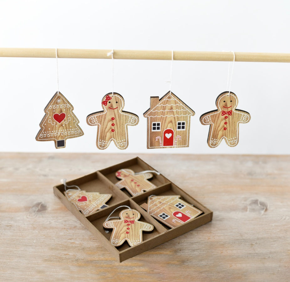 A pack of wooden gingerbread-shaped hanging decorations, including a gingerbread person, tree and house.