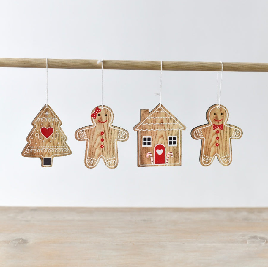 A pack of wooden gingerbread-shaped hanging decorations, including a gingerbread person, tree and house.
