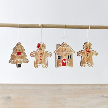 A pack of wooden gingerbread-shaped hanging decorations, including a gingerbread person, tree and house.