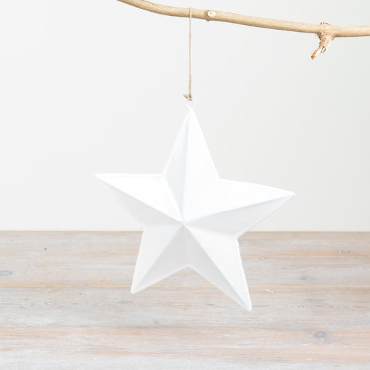 A large white star-shaped Christmas decoration with a smooth finish and a jute string hanger.