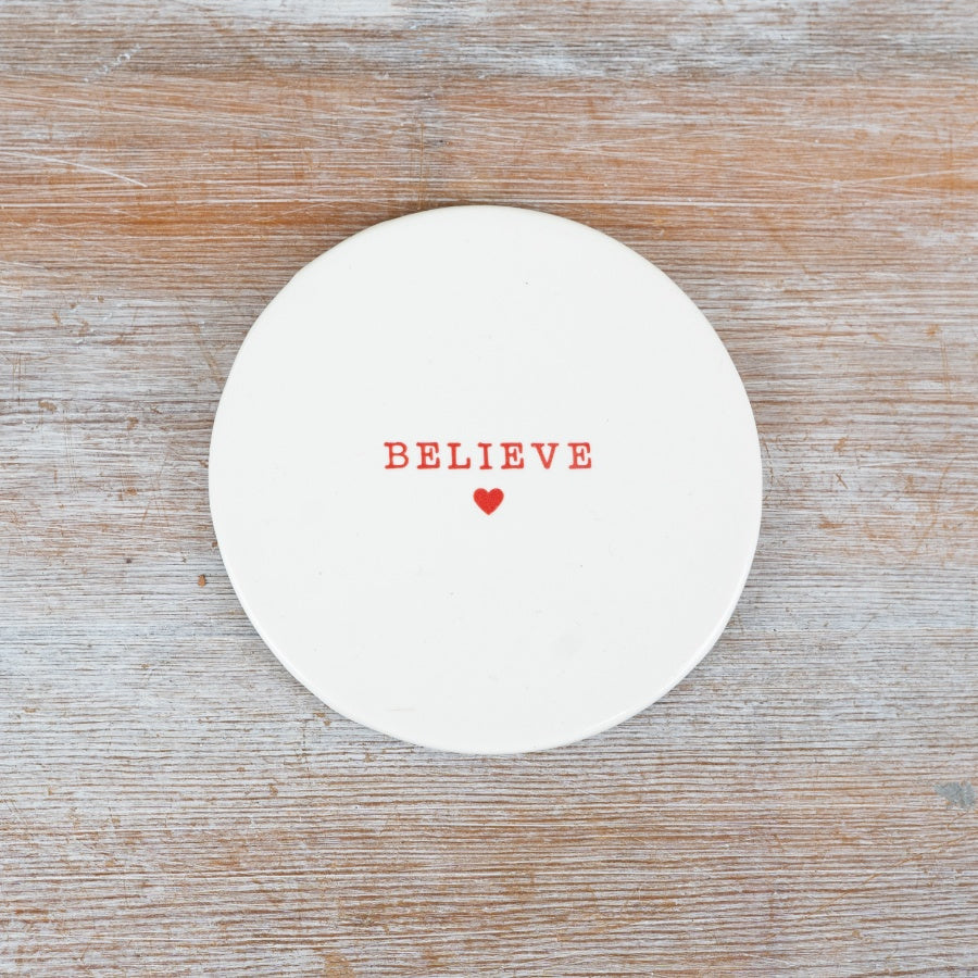 Simple white ceramic Christmas coaster, each with a different festive phrase and a small red heart.