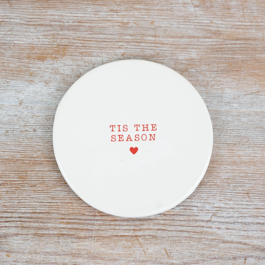 Simple white ceramic Christmas coaster, each with a different festive phrase and a small red heart.