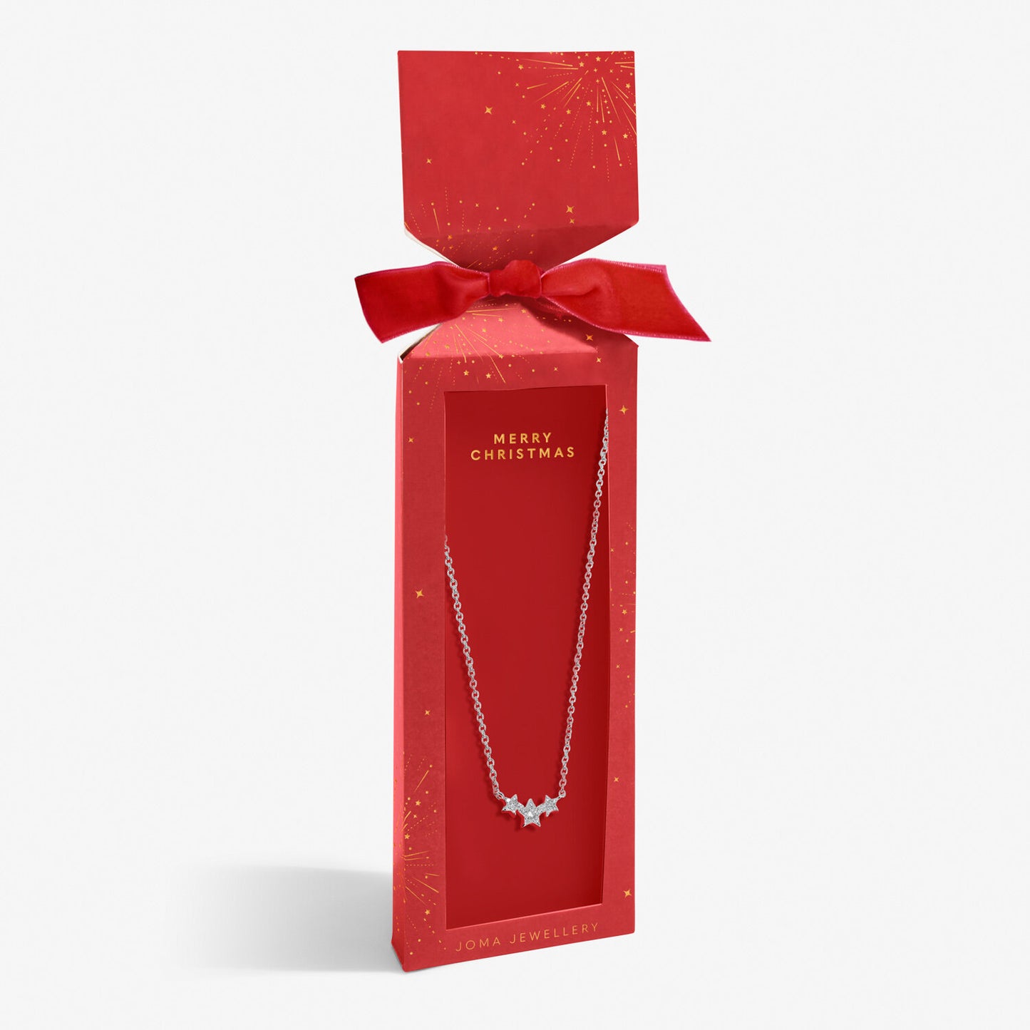 Joma silver-plated star necklace in a red gift box with starburst print, 'Merry Christmas' text and a bow.
