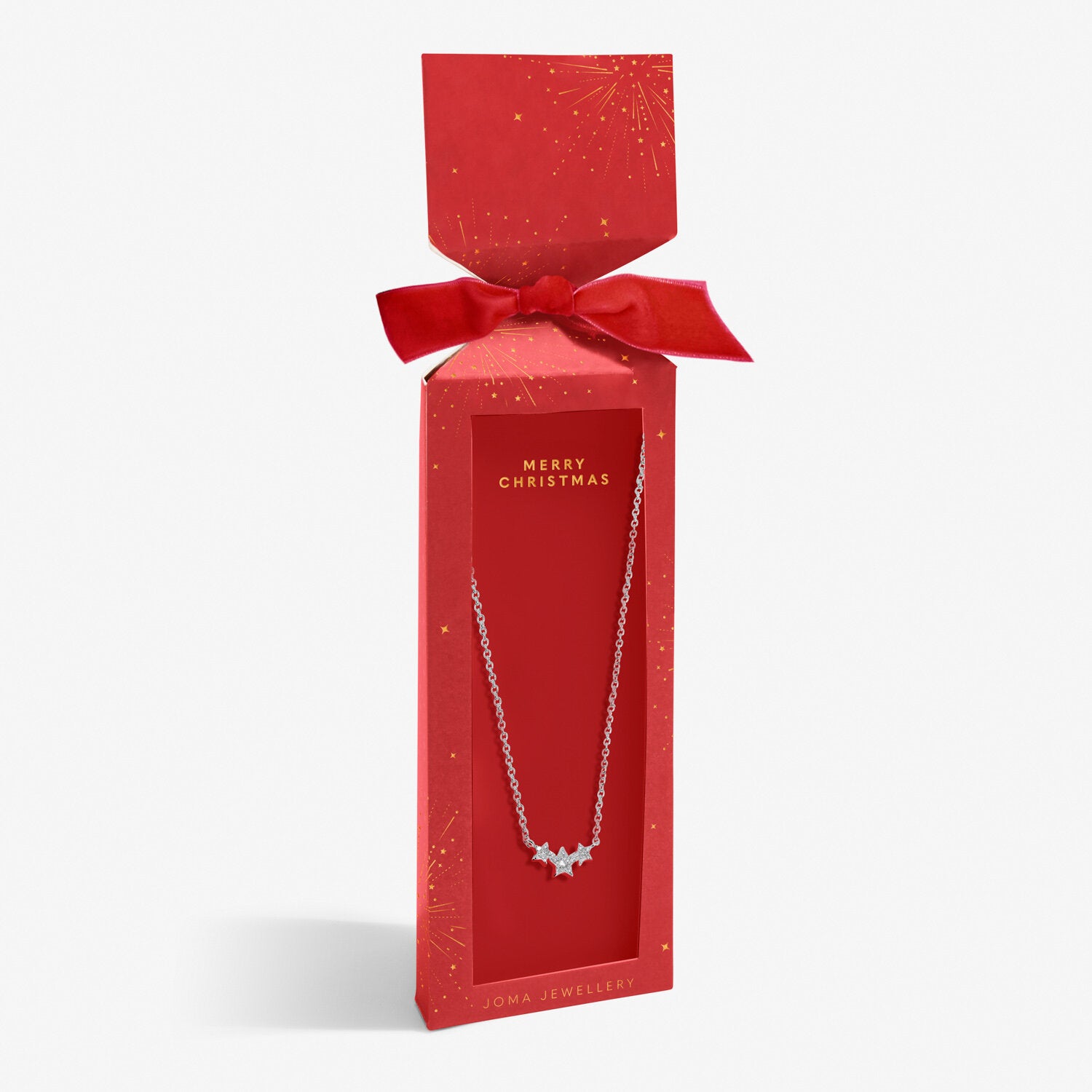 Joma silver-plated star necklace in a red gift box with starburst print, 'Merry Christmas' text and a bow.