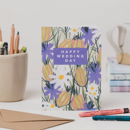 Luxury A6 greetings card with 'happy wedding day' text and purple flowers and white daisies illustration, blank inside, printed on 350gsm UK card