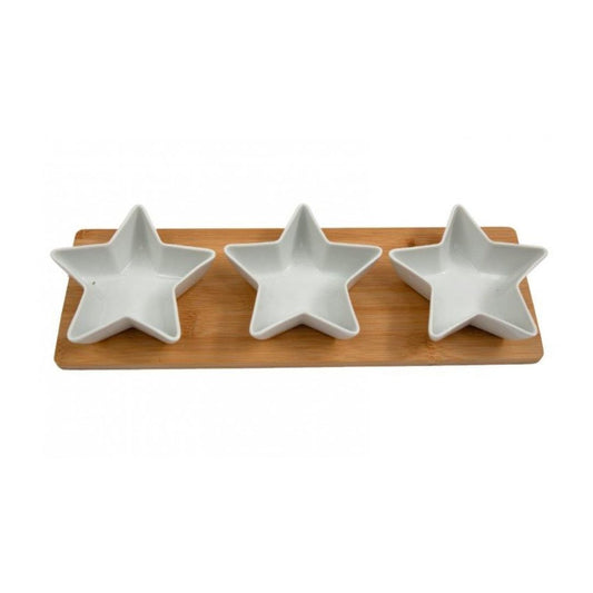 A long, rectangular wooden serving board with three small, star-shaped white ceramic bowls nested inside.