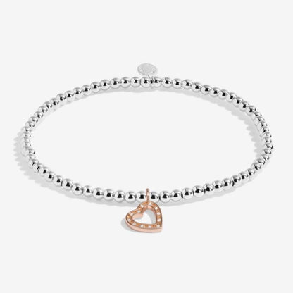 Silver plated stretch beaded bracelet with rose gold and sparkle heart shaped charm