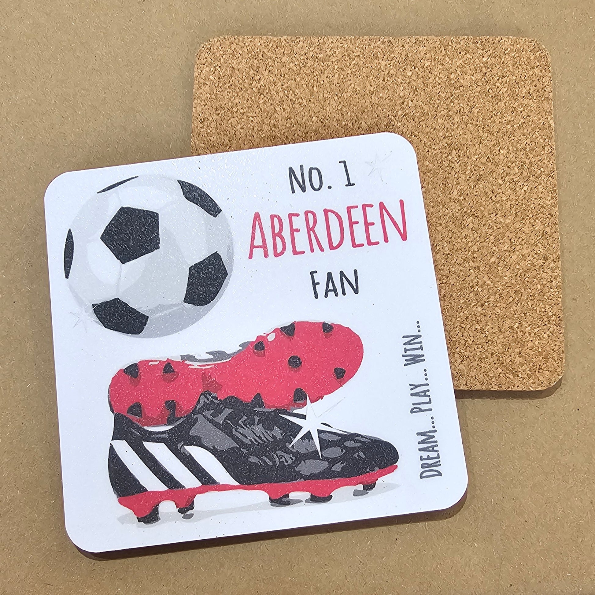 A square coaster with a cork base, featuring a football design with the text 'NO. 1 ABERDEEN FAN' and an image of a soccer ball and cleats.