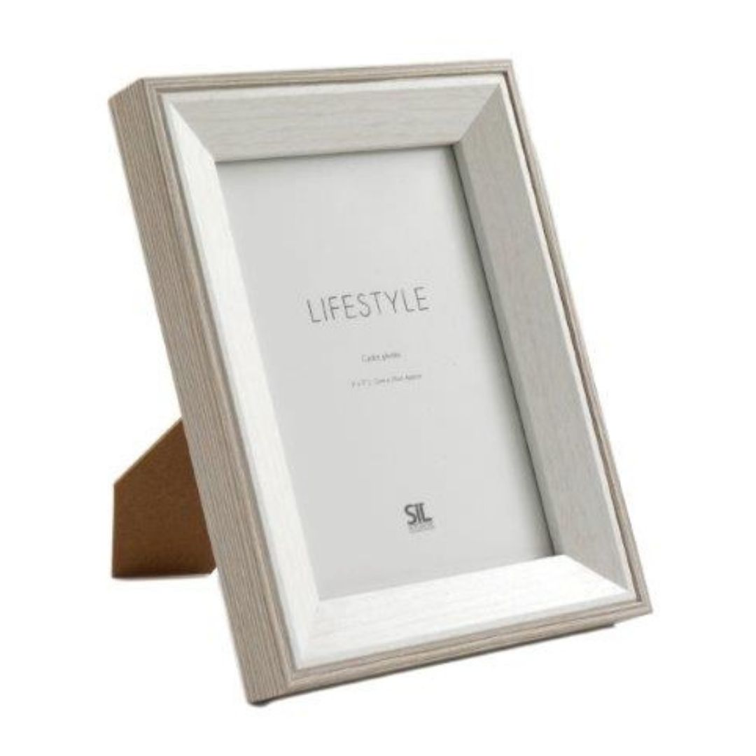 A white wooden photo frame with an antique, rustic finish and decorative detailing