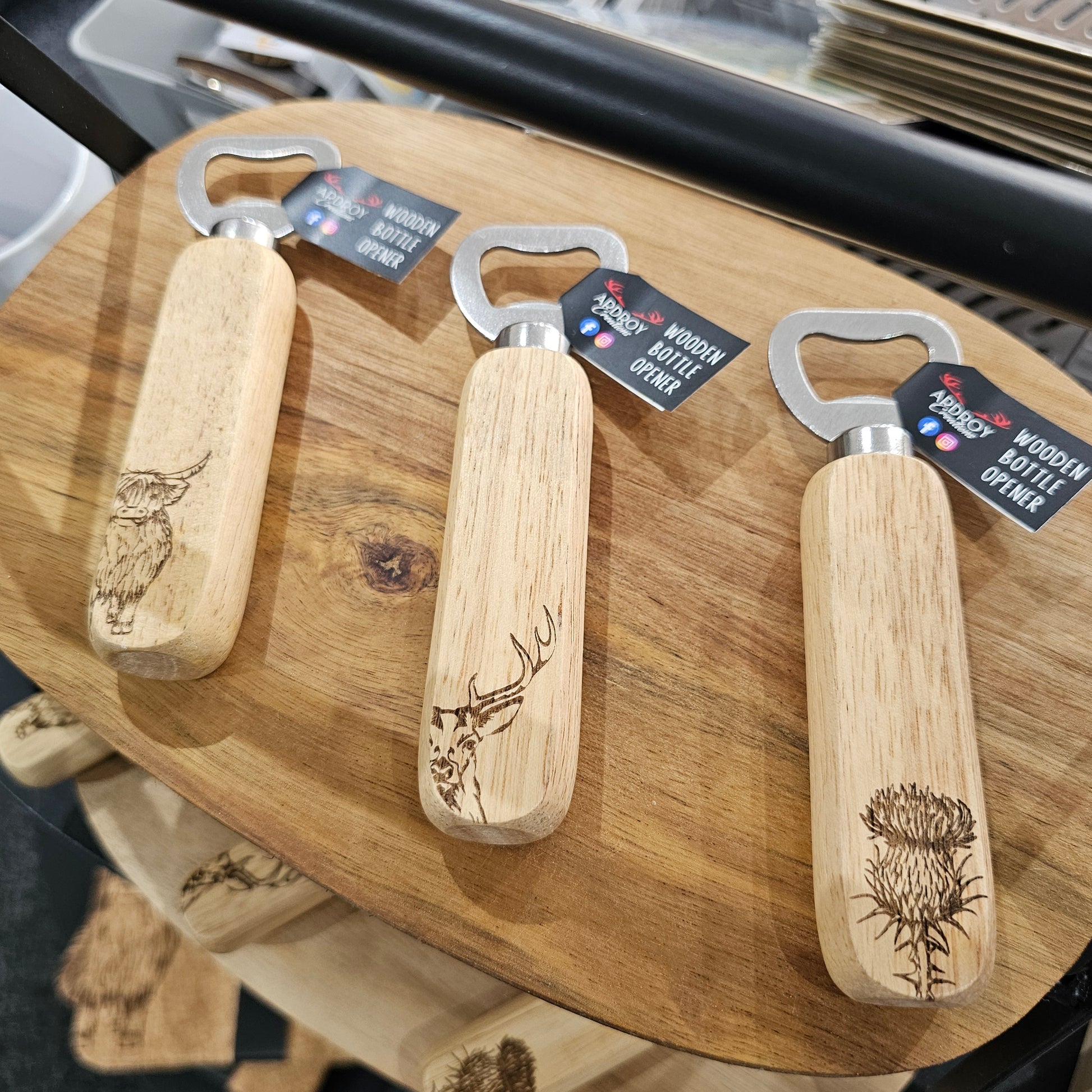 Scottish wooden bottle openers by Ardroy Creations with stainless steel hardware and Highland Coo, Stag or Thistle design