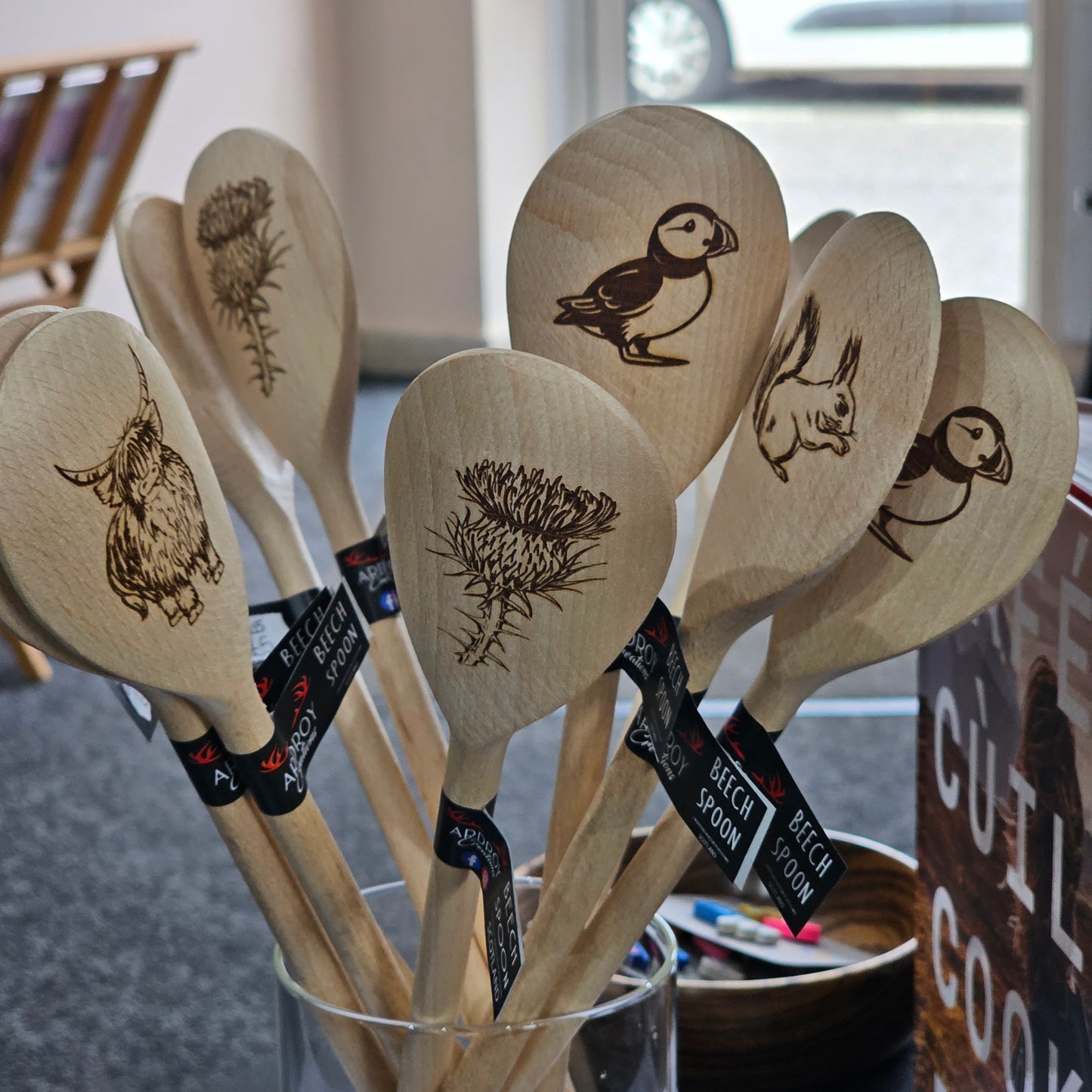Scottish solid beech wooden spoons by Ardroy Creations with Highland Coo, Stag, Thistle, Puffin and Red Squirrel designs.