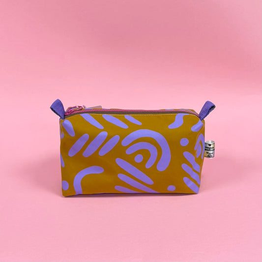 Handmade boxy cosmetic pouch made in Dundee from water-resistant wax cotton, screen printed and fully lined for makeup and toiletries.