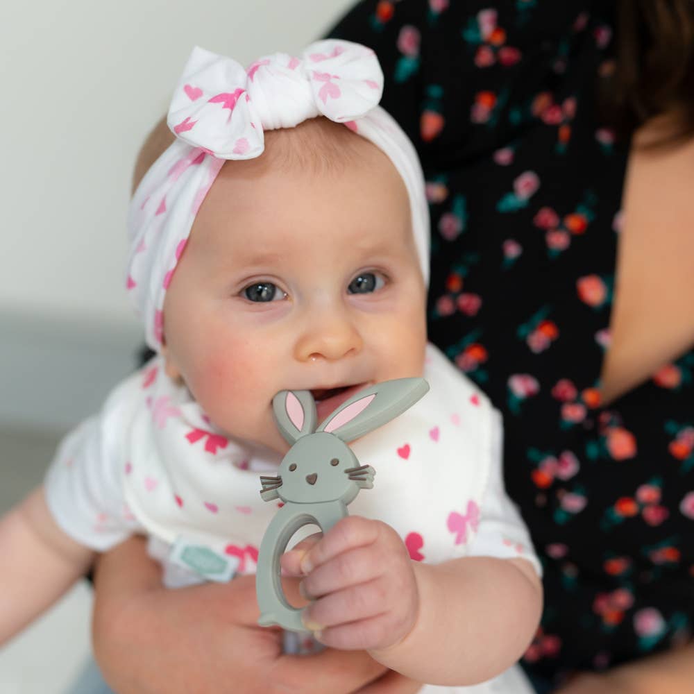 Baby holding a Silicone baby teether BPA free gum soothing teether Bunny design