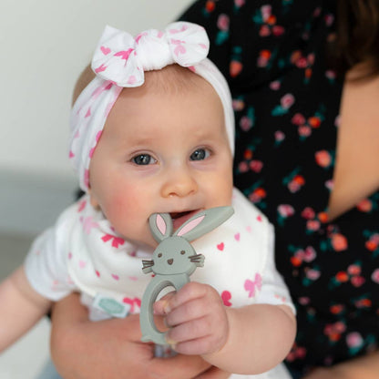 Baby holding a Silicone baby teether BPA free gum soothing teether Bunny design