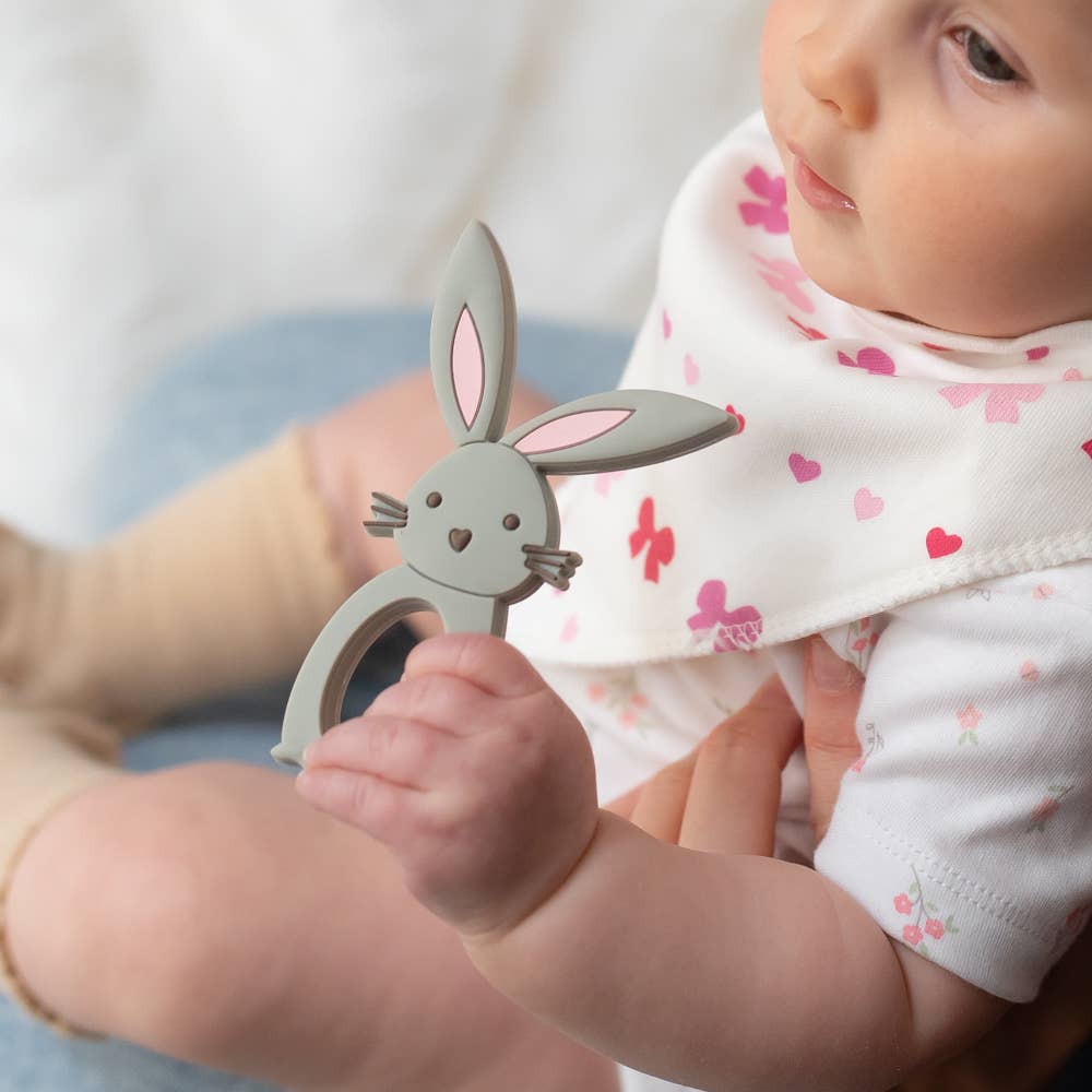 Baby holding a Silicone baby teether BPA free gum soothing teether Bunny design