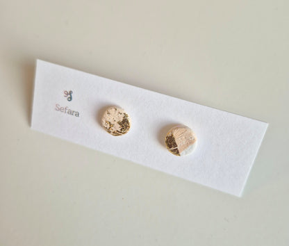 Beige White and Gold Sefara round stud earrings on a branded card