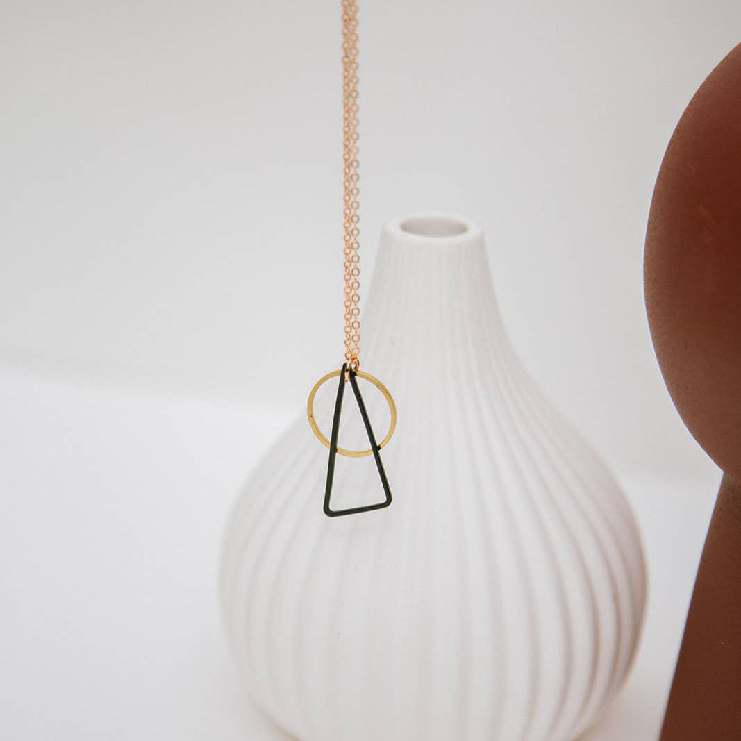 Copper Bee Black + Brass necklace with oxidised black triangle and open gold-plated circle pendant