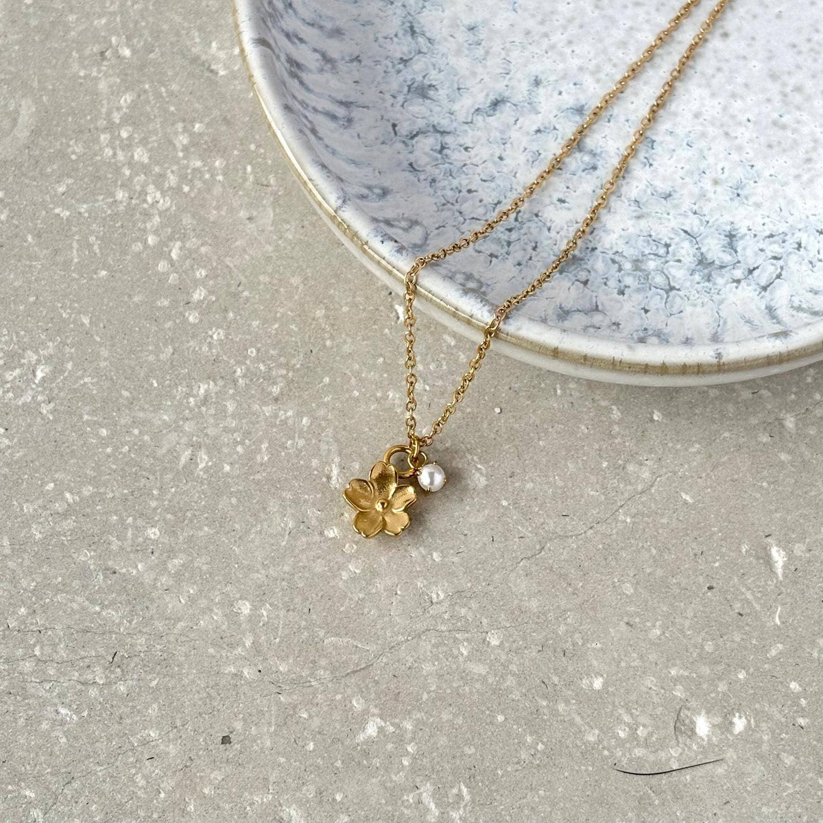 Flax Barn Blossom Flower Necklace with delicate pearl detail, crafted from tarnish-resistant PVD-plated stainless steel.
