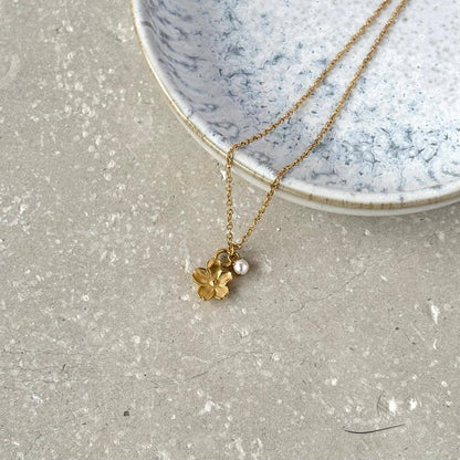 Flax Barn Blossom Flower Necklace with delicate pearl detail, crafted from tarnish-resistant PVD-plated stainless steel.