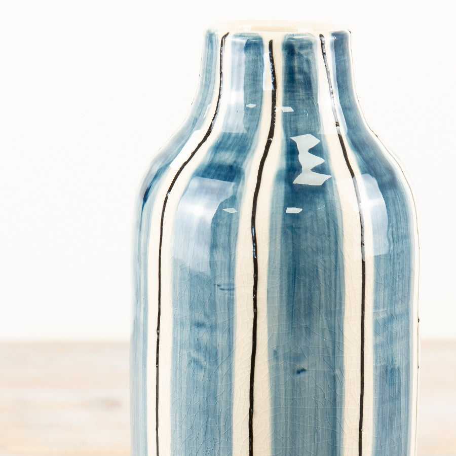 Blue and white striped ceramic decorative vase ideal for flowers or as a standalone statement piece in any home décor setting.