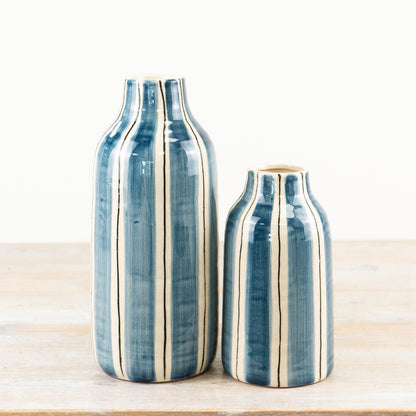 Two blue and white striped ceramic decorative vases ideal for flowers or as a standalone statement piece in any home décor setting.