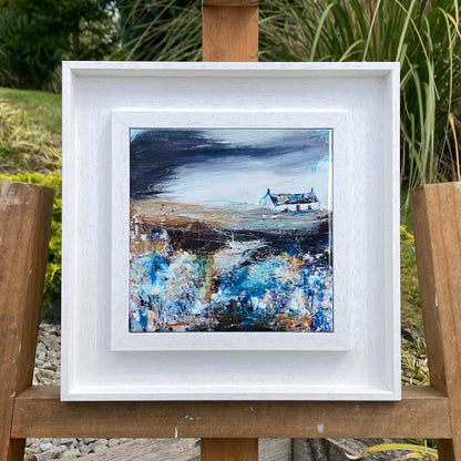 A ceramic tile print of a colourful painting titled 'Bluebells', showing a small house nestled in the Scottish Highlands, available mounted on natural slate or framed.
