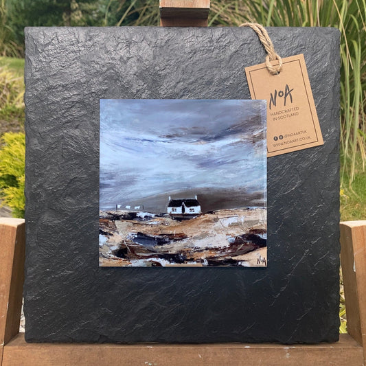 A ceramic tile print of a colourful painting titled 'Blustery Days', showing a small house nestled in the Scottish Highlands, available mounted on natural slate or framed.