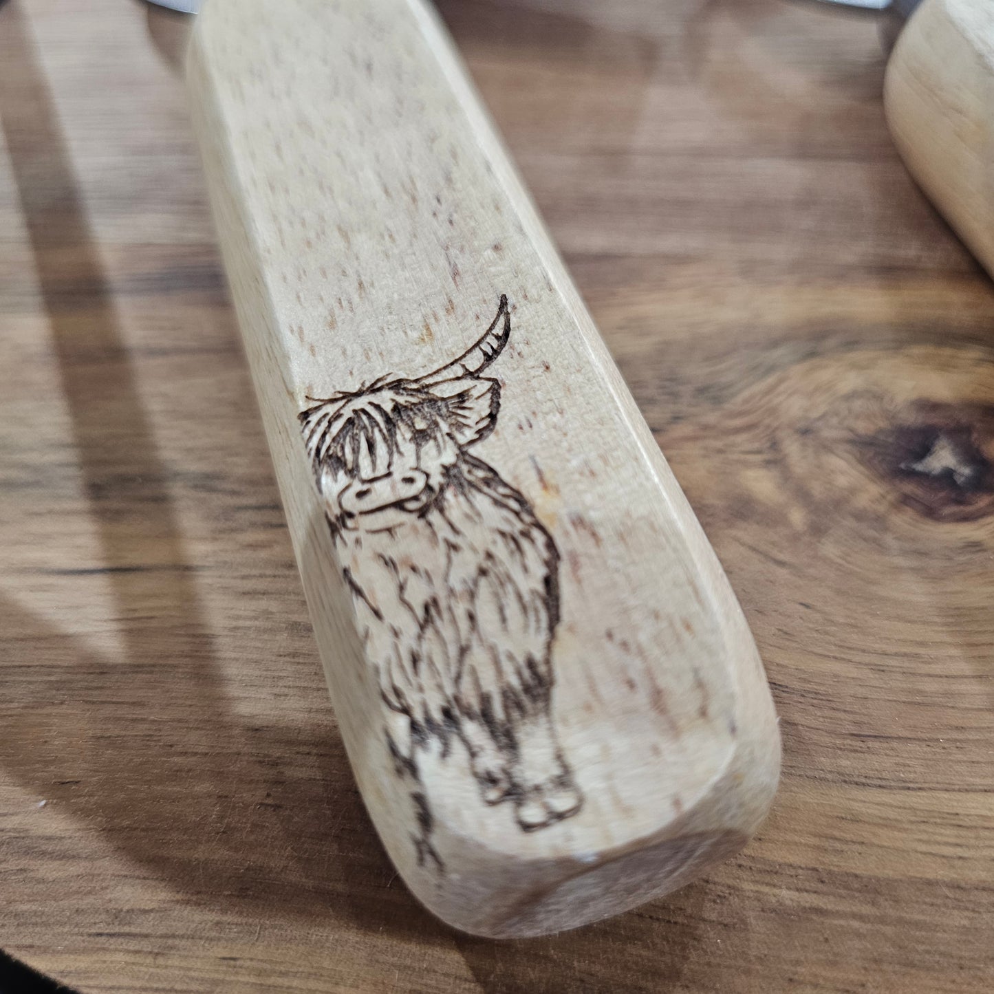 Scottish wooden bottle opener by Ardroy Creations with stainless steel hardware and Highland Coo design