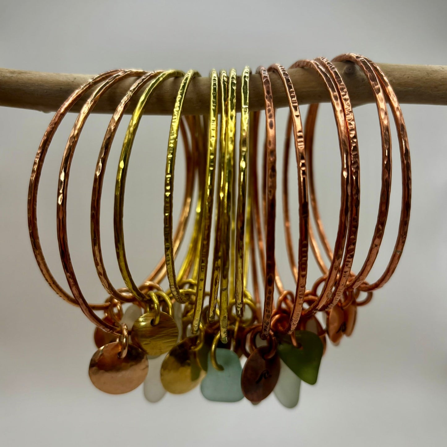Handmade brass, copper and bronze bangles by Rowan Berry Jewellery with genuine sea glass collected from beaches around Carnoustie
