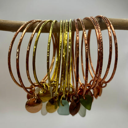 Handmade brass, copper and bronze bangles by Rowan Berry Jewellery with genuine sea glass collected from beaches around Carnoustie