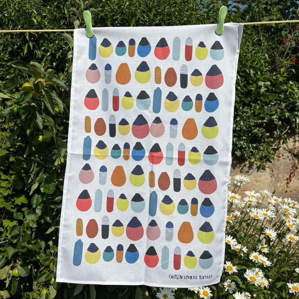 Caitlin Sparks Textiles organic cotton tea towel featuring a colourful coastal buoy pattern