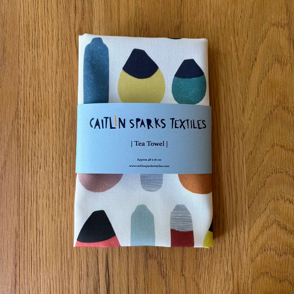 Caitlin Sparks Textiles organic cotton tea towel featuring a colourful coastal buoy pattern