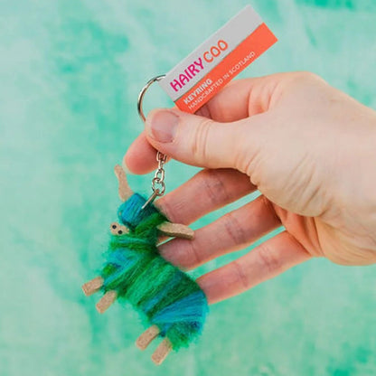 A handcrafted Hairy Coo keyring in the shape of a Highland cow wrapped in hand-dyed mohair