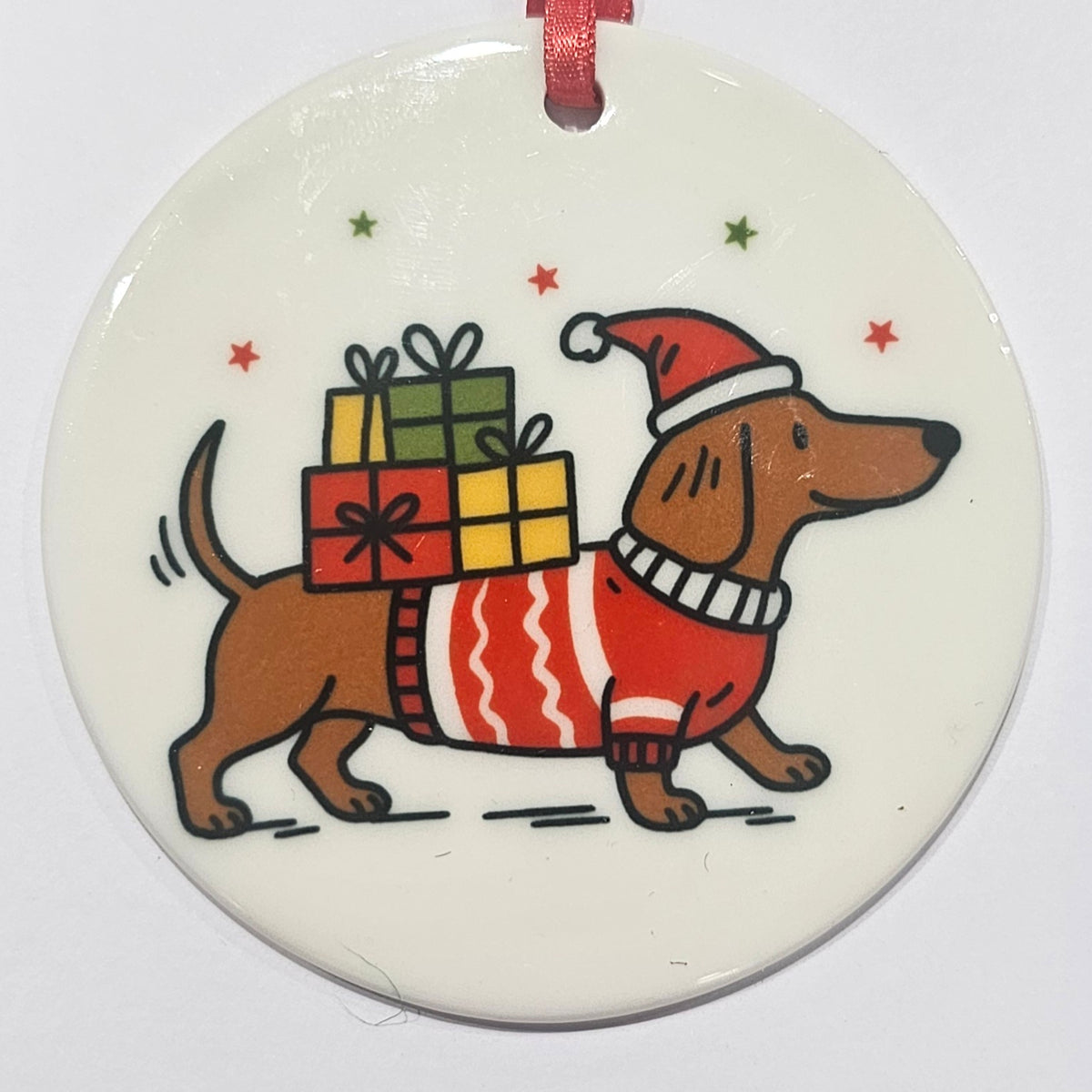 Ardroy Creations round ceramic Christmas baubles in Carnoustie Golf, Highland Cow and Dachschund designs, each 7cm in diameter with festive ribbon and presentation card.
