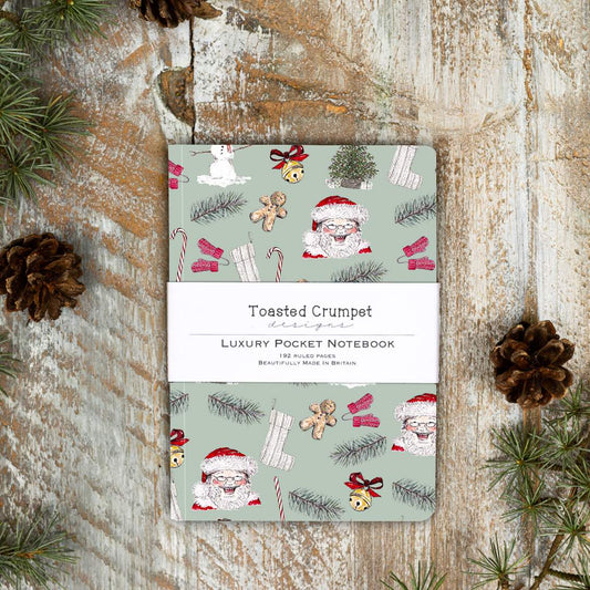 All Things Jolly Sage Green luxury A6 notebook by Toasted Crumpet with festive design and 192 ruled pages