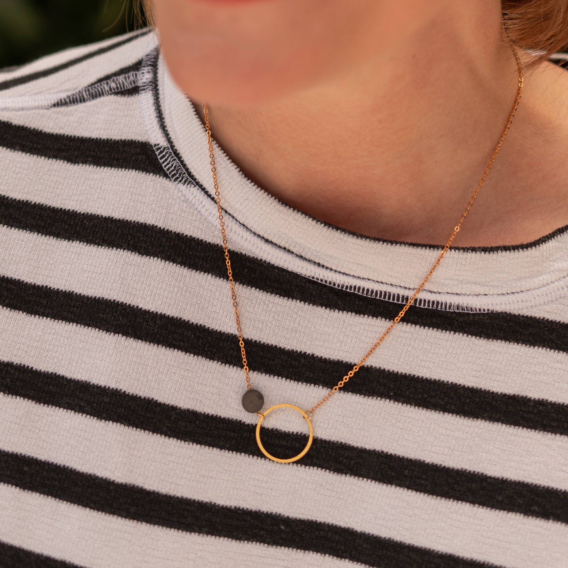 Copper Bee black and gold geometric necklace with open circle pendant and oxidised black disc