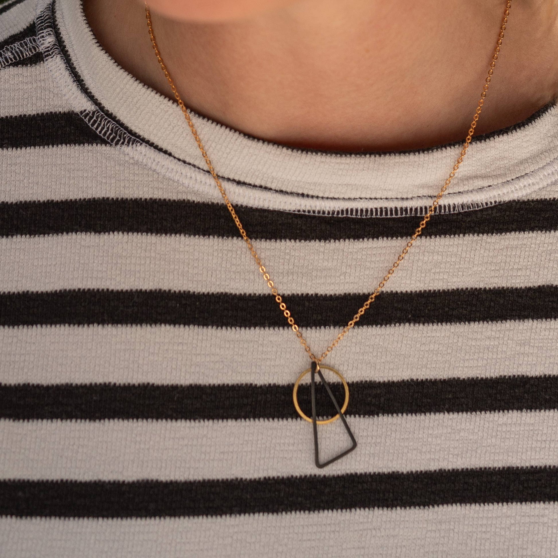 Copper Bee Black + Brass necklace with oxidised black triangle and open gold-plated circle pendant