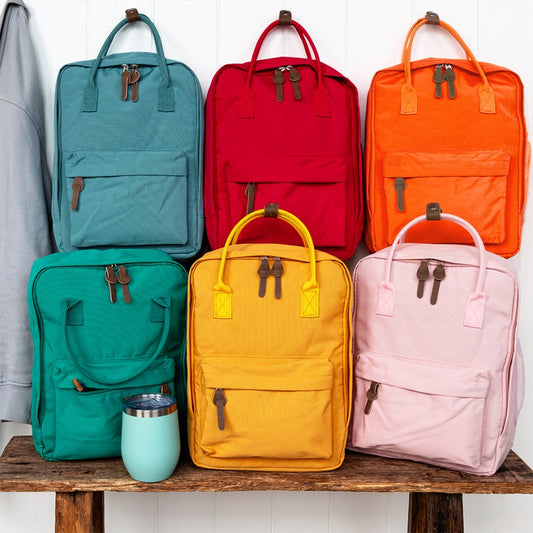 Stylish daily rucksacks with roomy main compartment and double zip, available in Red, Pink, Blue or Yellow