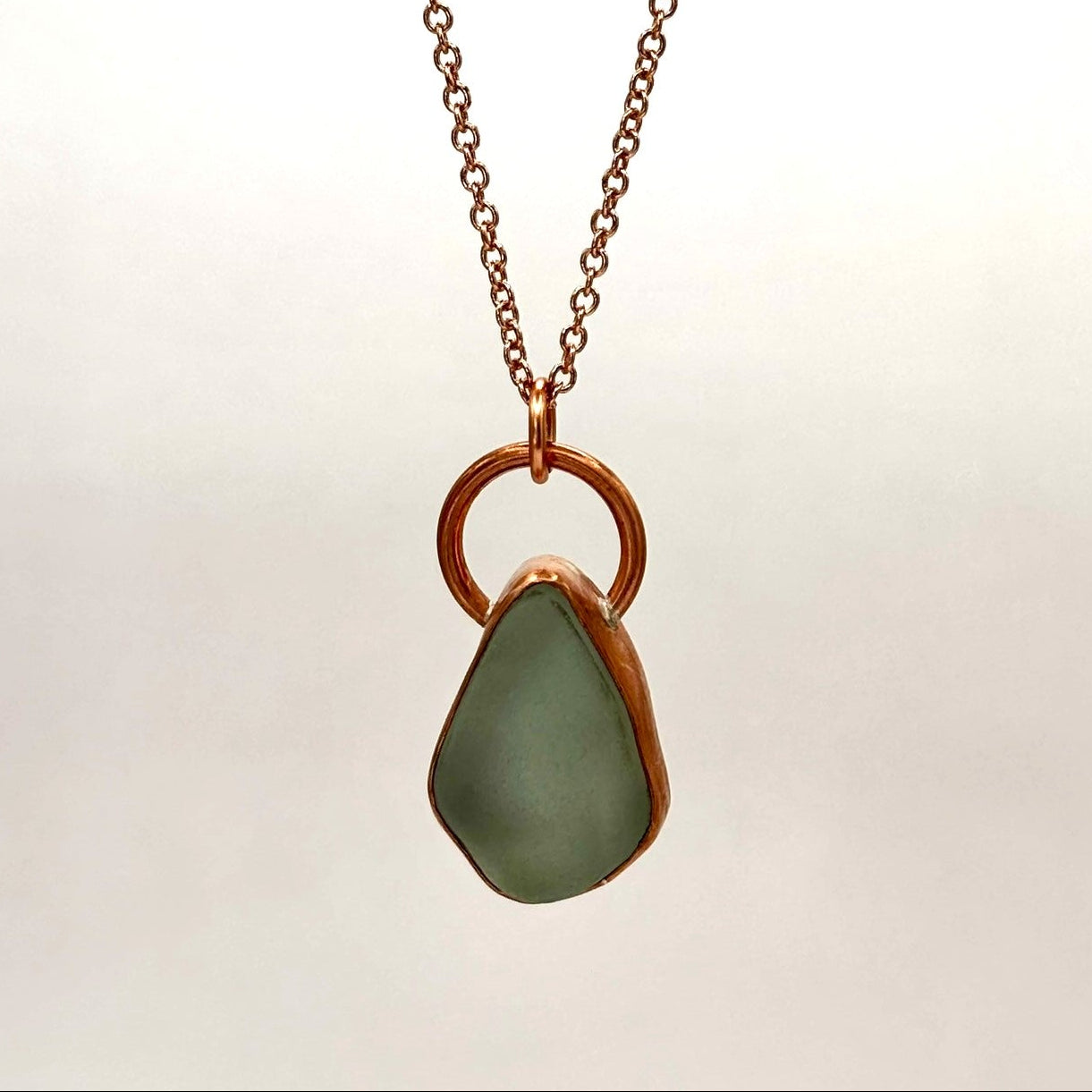 Copper bezel set white sea glass necklace by Rowan Berry Jewellery handmade in Carnoustie with locally collected sea glass