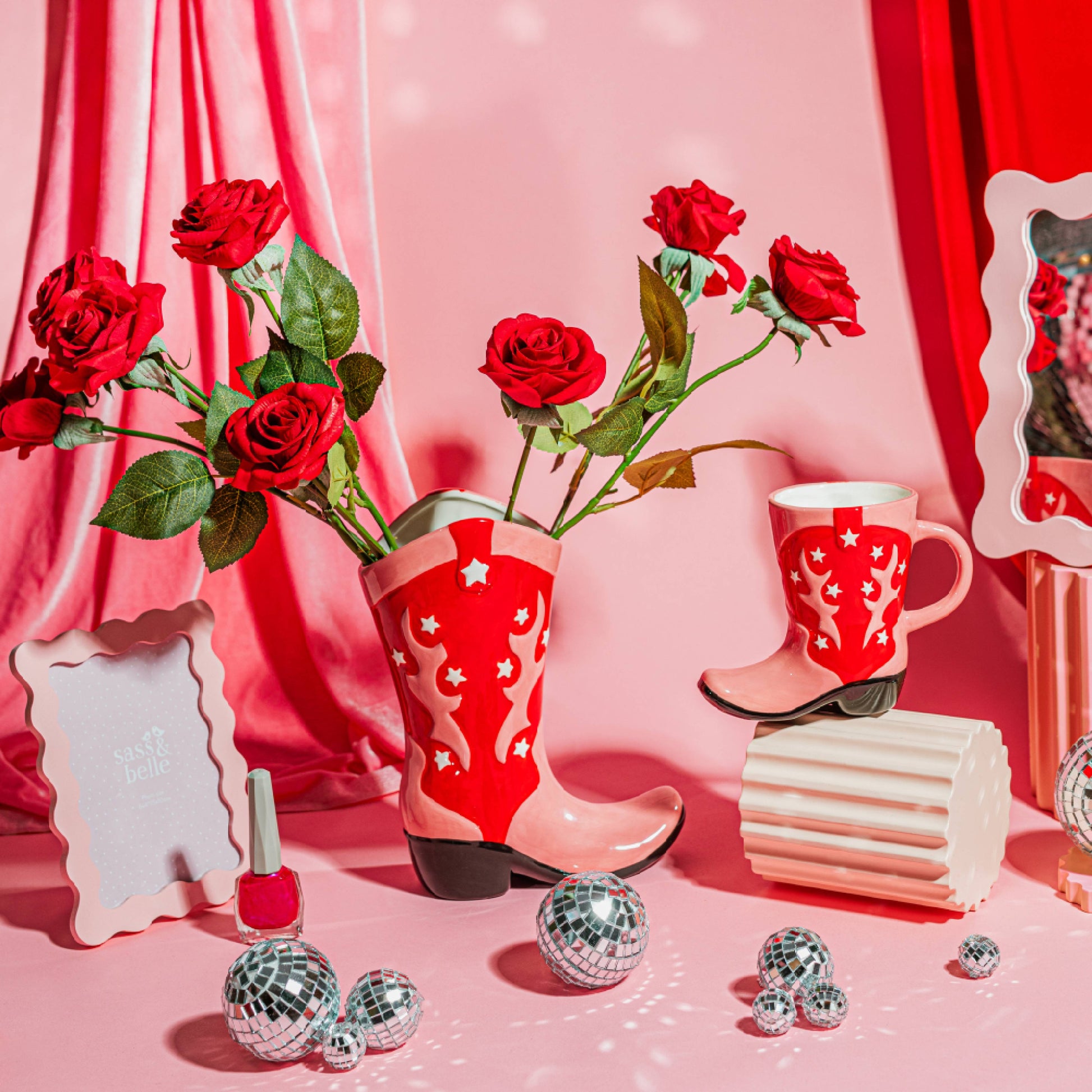 A vibrant red and pink Cowboy Boot Vase with white stars and patterns, designed to resemble a western-style boot.